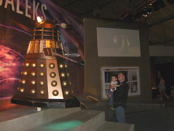 Daddy protects Thomas from a hovering Dalek